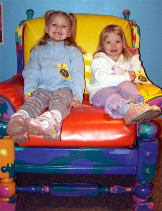 Rosa and Anna sitting in a chair