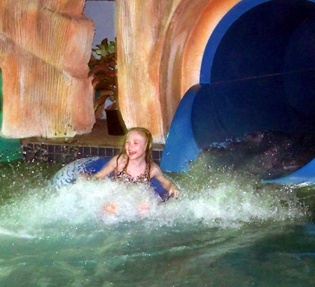 Nora coming out of a tube slide