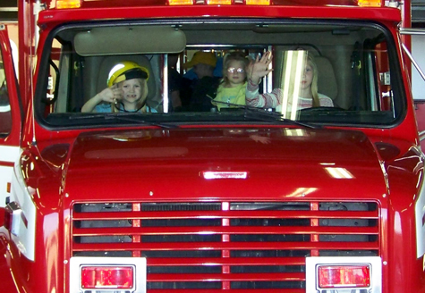 the girls at the front seats of the fire vehicle