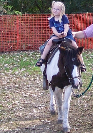 Anna riding a pony