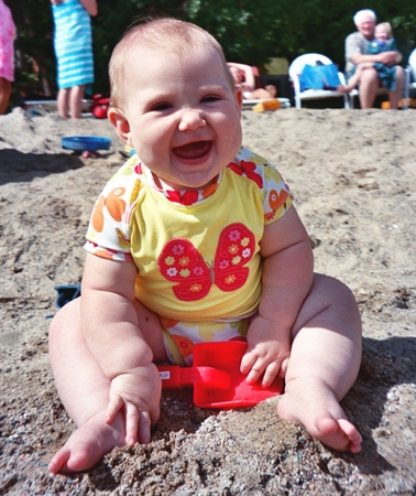 Ella on the beach smiling