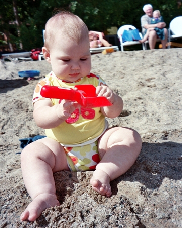 Ella holding a beach toy shovel
