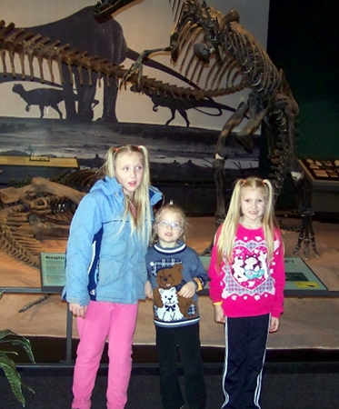 the girls pose with dino bones