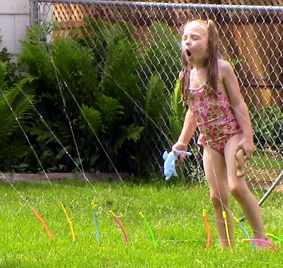 Anna in the sprinkler