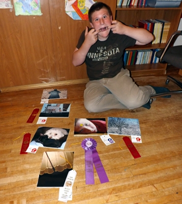 Corbin with his photos and ribbons