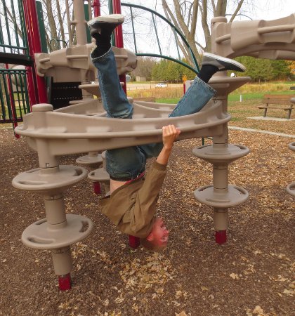 Alex upside down on the playground