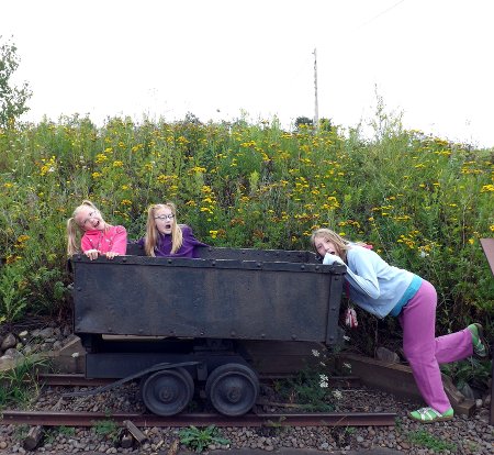 the girls as miners playing with a mine car