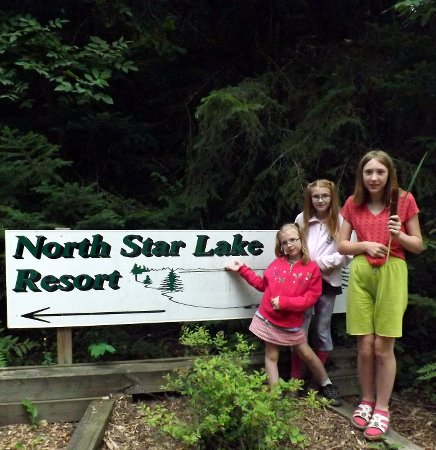 the girls next to the resort sign