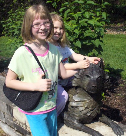 Ella and Anna with a wolf statue