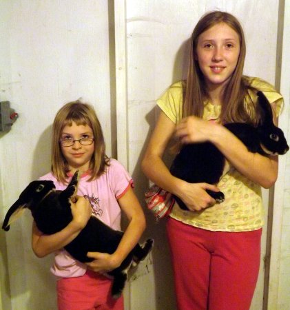 Anna and Nora holding rabbits