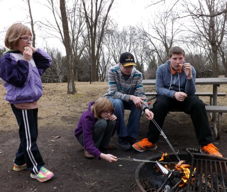 Anna, Rosa, Caleb, and Corbin roasting stuff 'round the ol' campfire