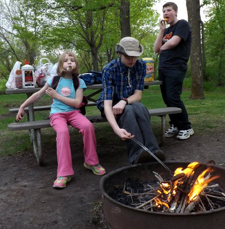 Caleb, Corbin, and Anna at the campfire