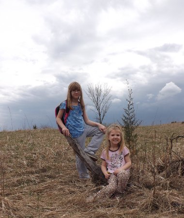 The girls pose for a shot on the prairie, with the storm clouds as a back-drop