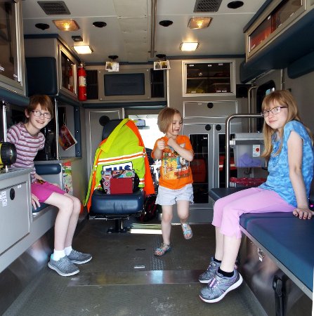 the girls in back of a ambulance vehicle
