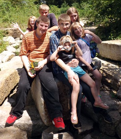 all seven kids on a rock