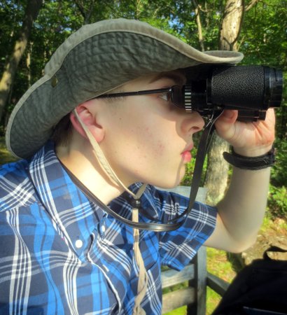 Caleb looking through binoculars
