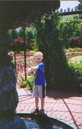 Caleb with hand in fountain