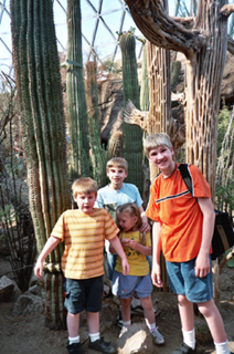 the kids in front of some cactuses