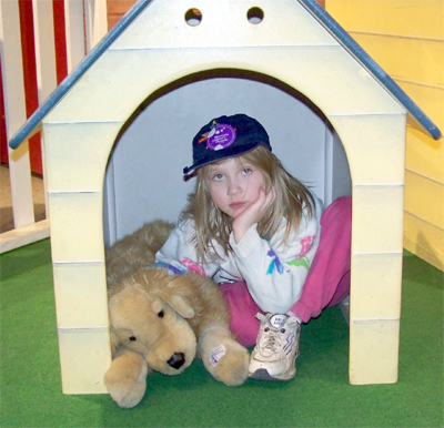 Nora and a dog in a doghouse