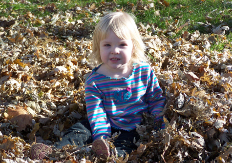 Anna in a leaf pile