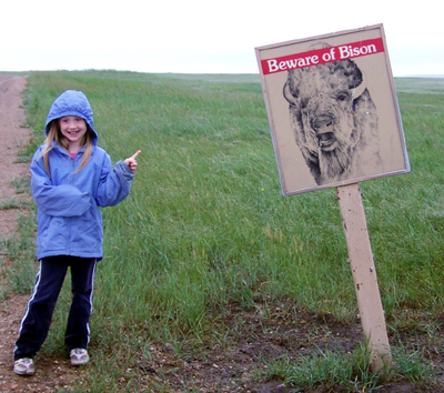 Nora next to a watch-for-bison sign