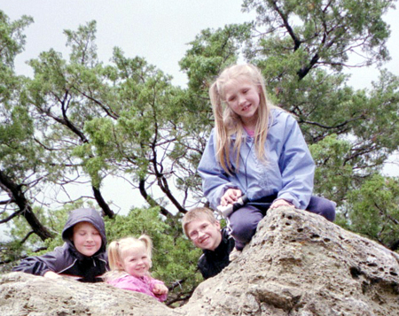 Corbin, Anna, Caleb and Nora on a rock