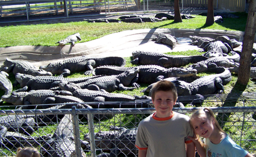 Corbin and Nora with lots of gators and crocs behind them